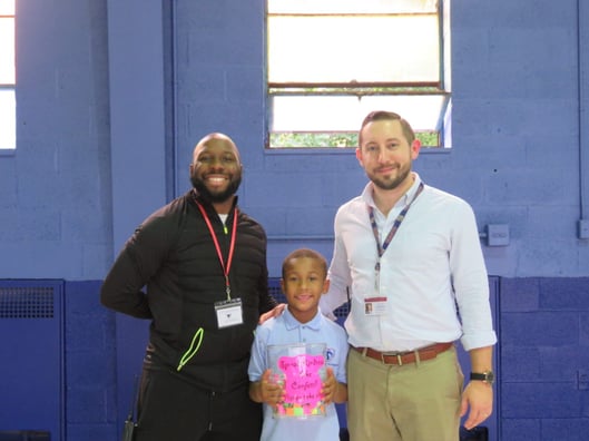 Dominic Frisina with a Syracuse Charter School teacher and a student
