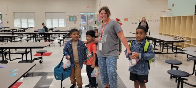 older-school-helping-younger-students-in-cafteria