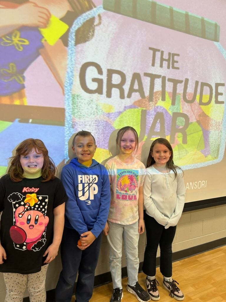 Schickler Elementary students standing in front of Gratitude Jar Presentation