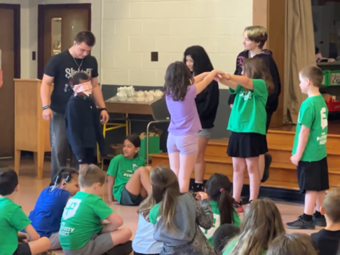 Nassau Elementary students practicing teamwork with older students