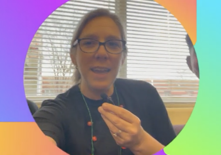 A woman speaking into camera for a video