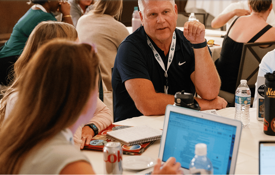 A table of people talking at a leadership retreat
