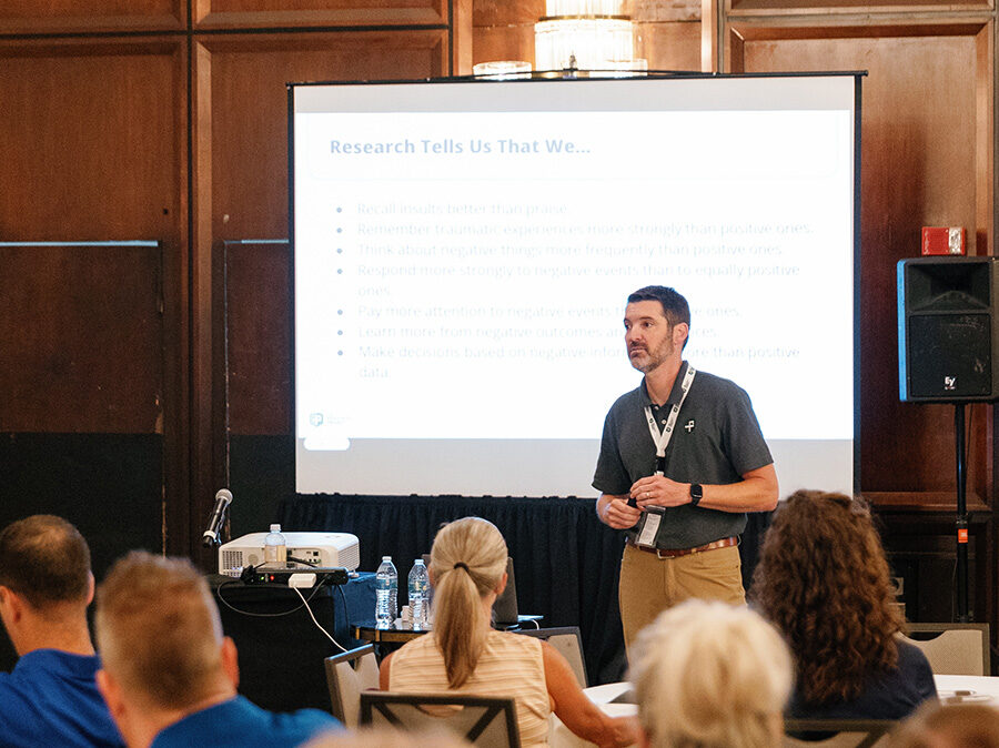Joe McDonough leading an on-site P2 training in front of projector