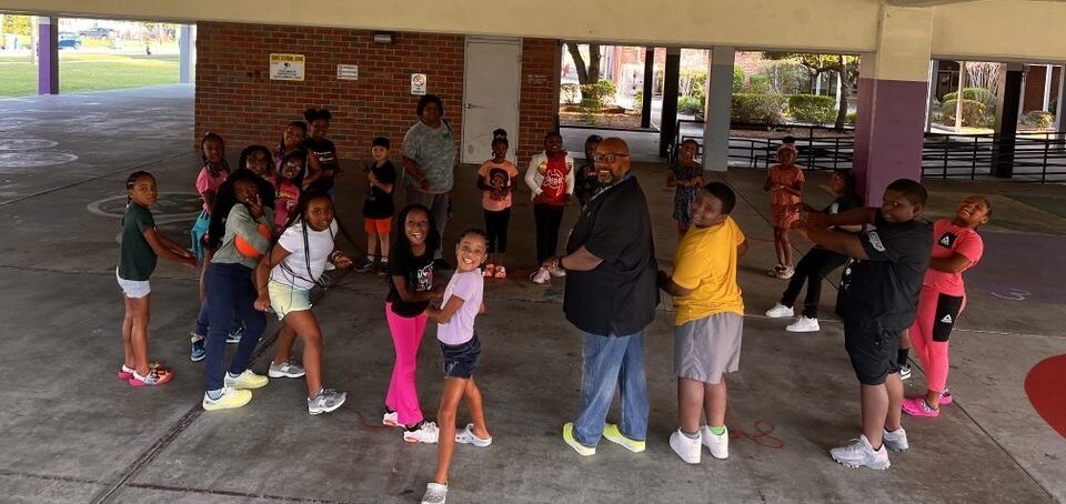 students holding hands in a circle