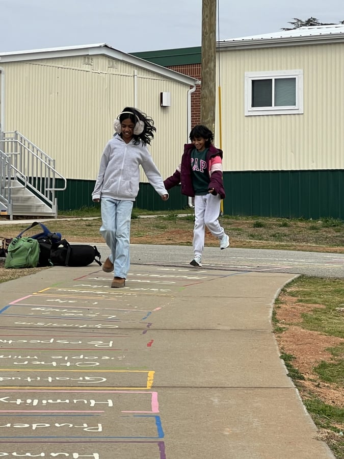 odell elementary students doing hopscotch on character strengths