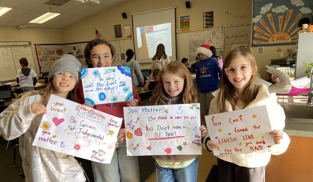 students holding posters with strengths