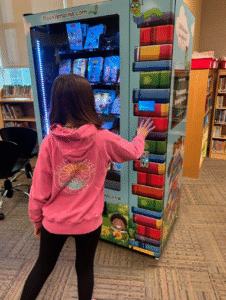 student using book vending machine at maplewood elementary