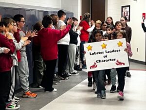children-holding-signs-in-hallway