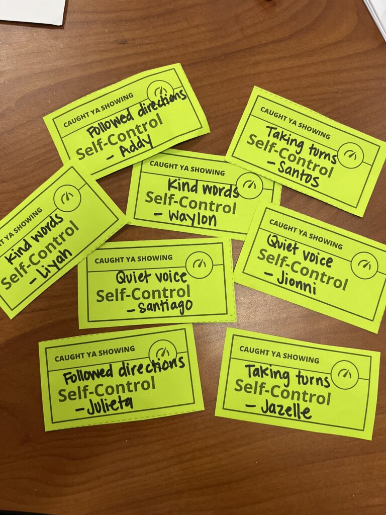 green-pieces-of-paper-on-desk-with-positive-affirmations
