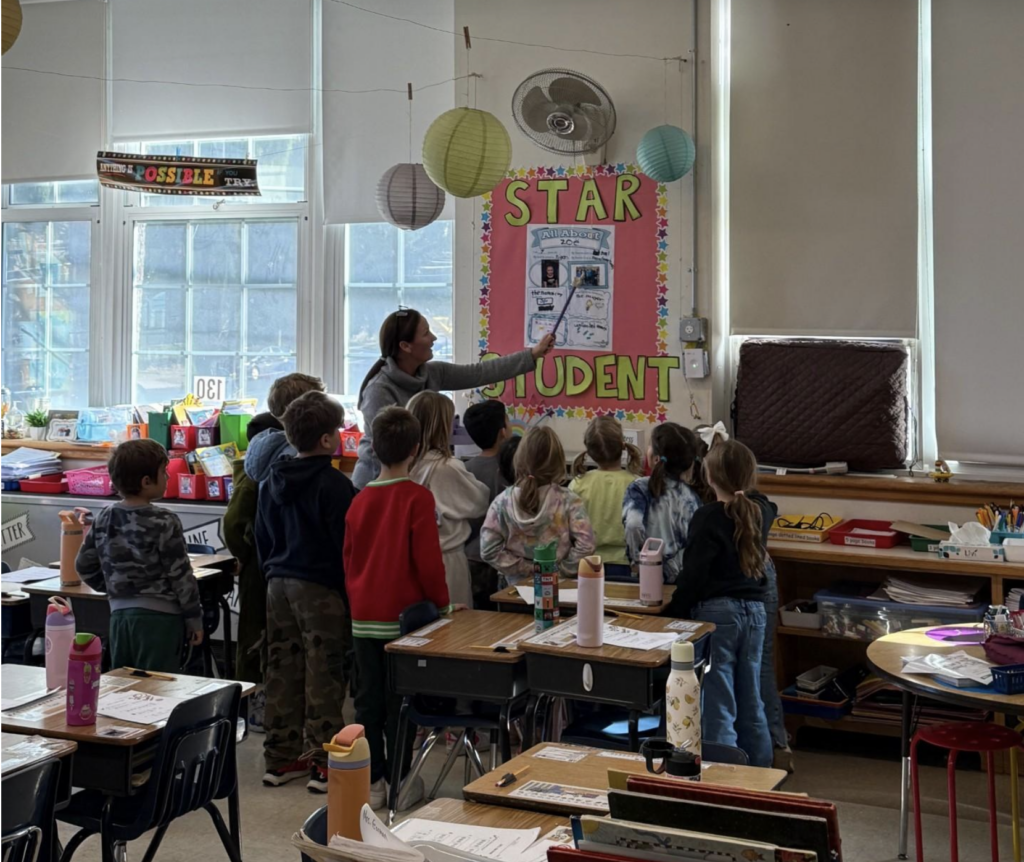 students-gathering-around-teacher
