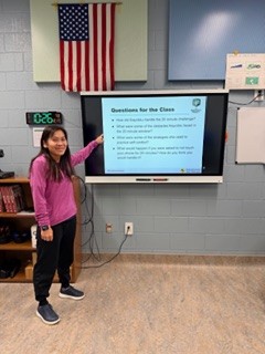 child-pointing-to-monitor-in-classroom