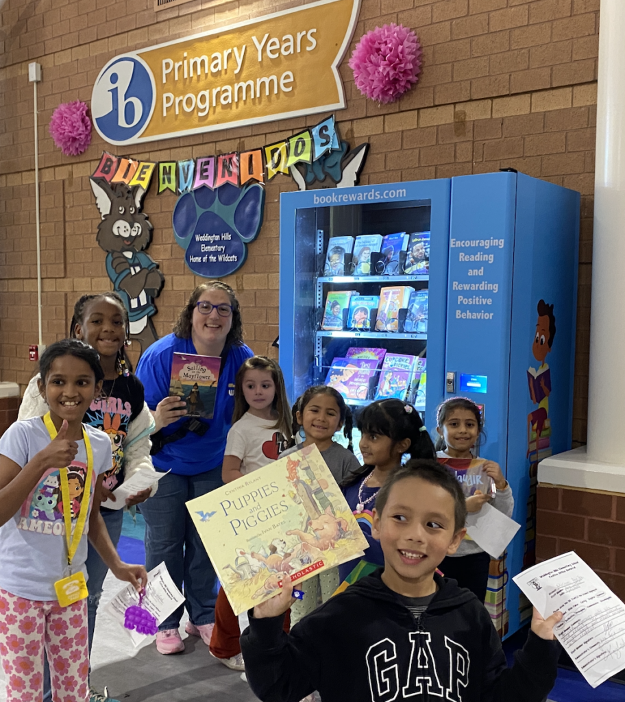 happy-students-pose-by-book-vending-machine