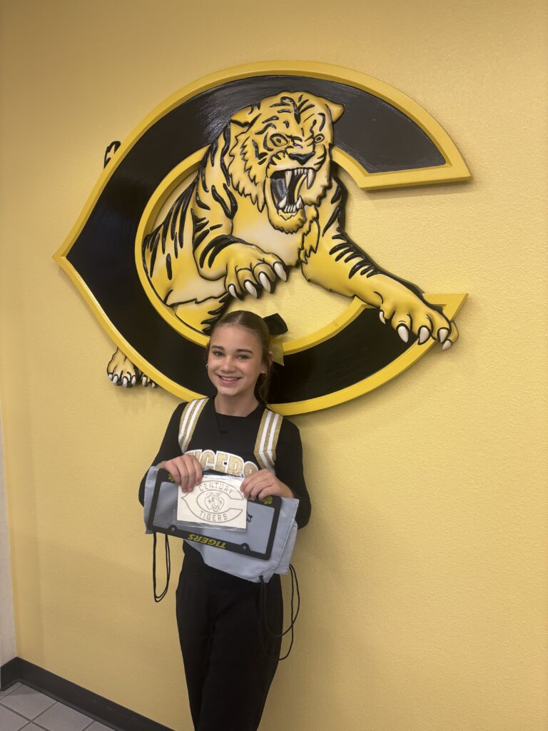 young-girl-wearing-all-black-in-front-of-tiger-logo-in-school-hallway