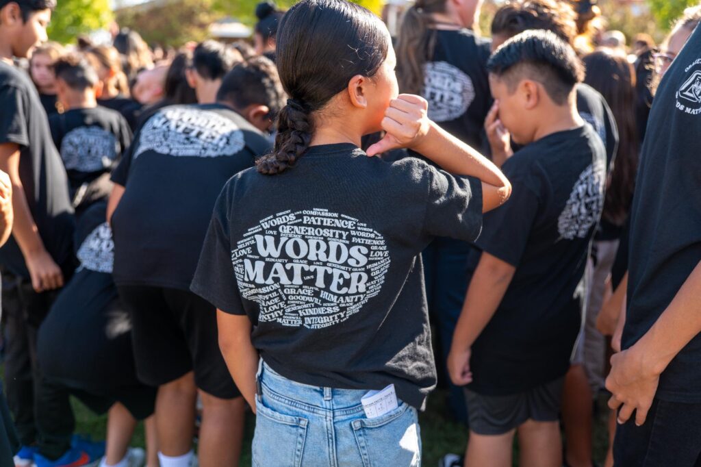 student-shows-off-the-back-of-her-shirt