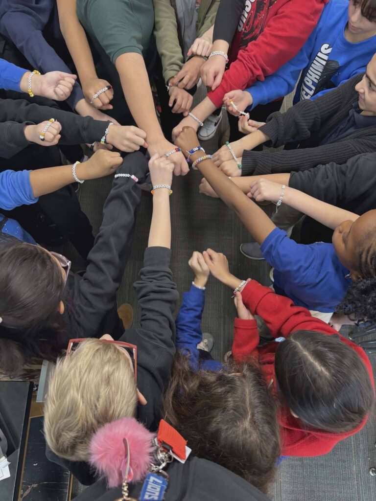kids-putting-arms-together-showing-off-bracelets