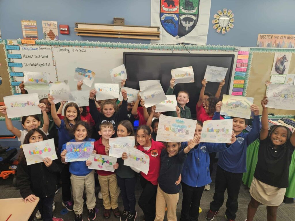 students-inside-classroom-holding-up-white-paper-signs-with-integrity-written-on-them