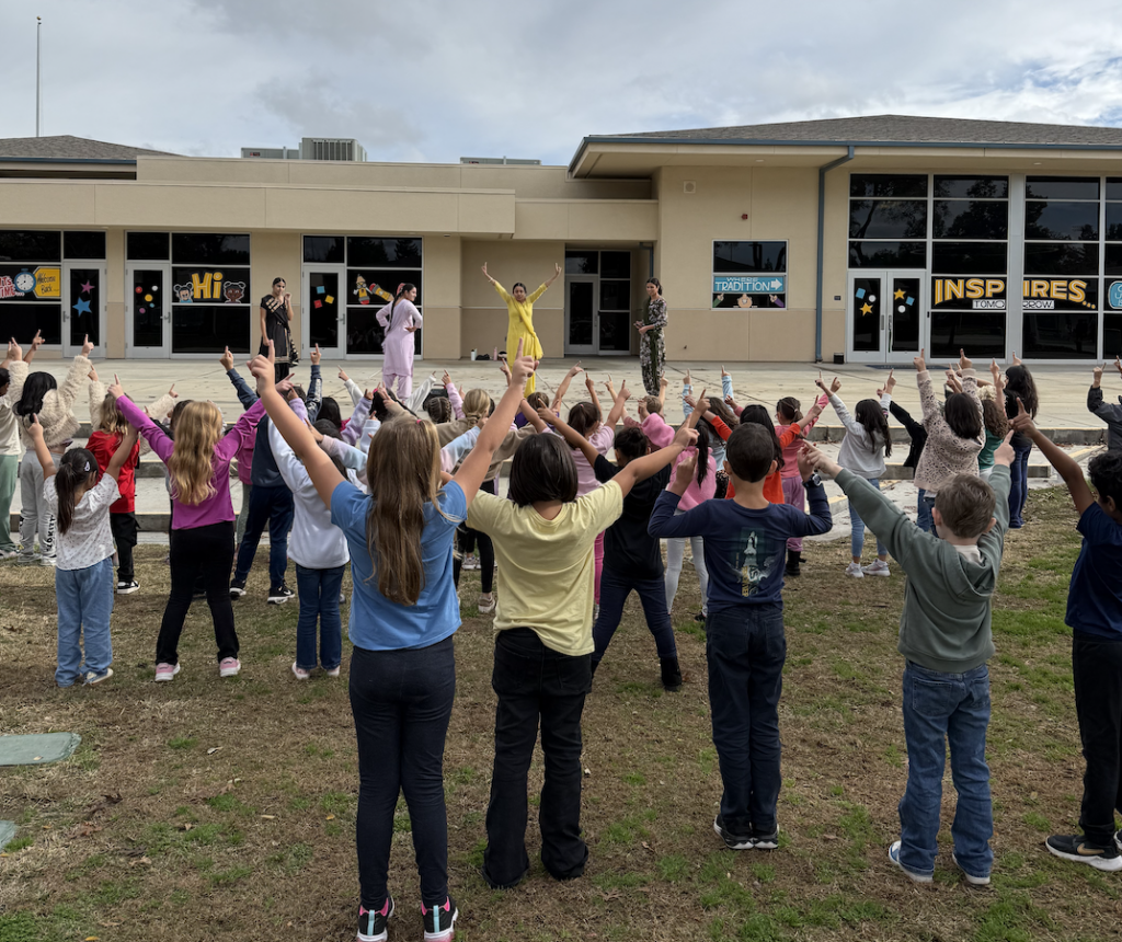 students-outside-learning-a-dance-from-older-students