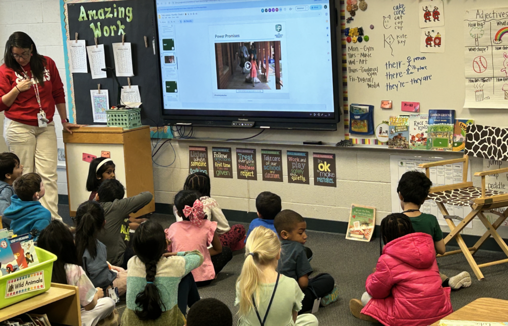students-on-classroom-floor-looking-at-screen