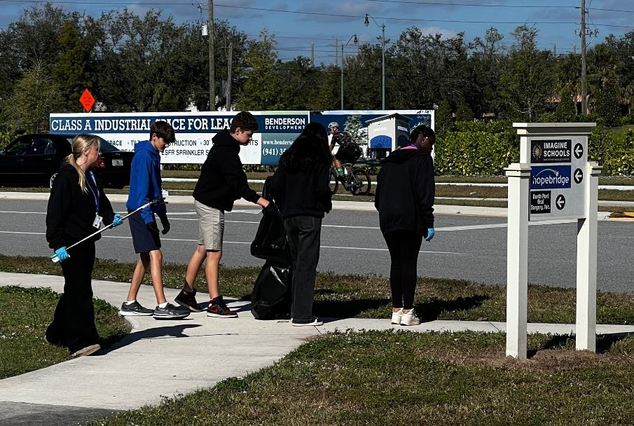 group-of-high-school-students-outside-picking-up-litter-in-trash-bags